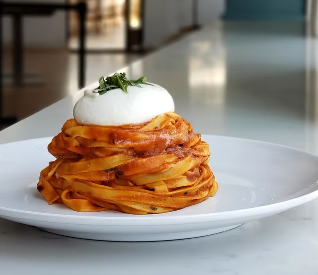 Tagliatelle pasta topped with burrata, used in an AI-generated 'Tonight only' SMS draft