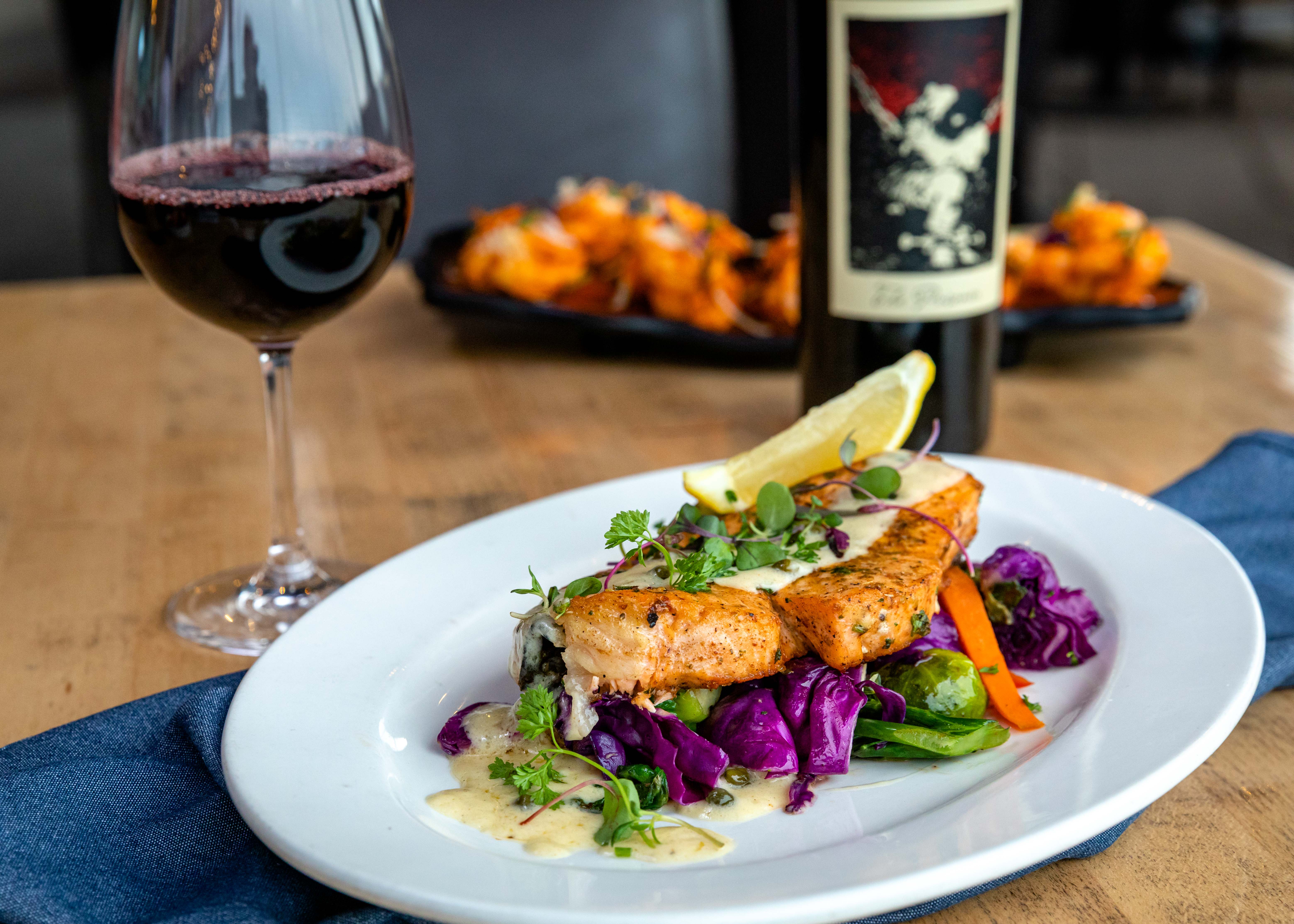 Plated salmon with lemon, herbs, and purple cabbage