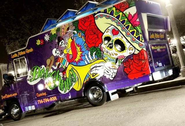 Purple food truck with a Day of the Dead sugar skull mural