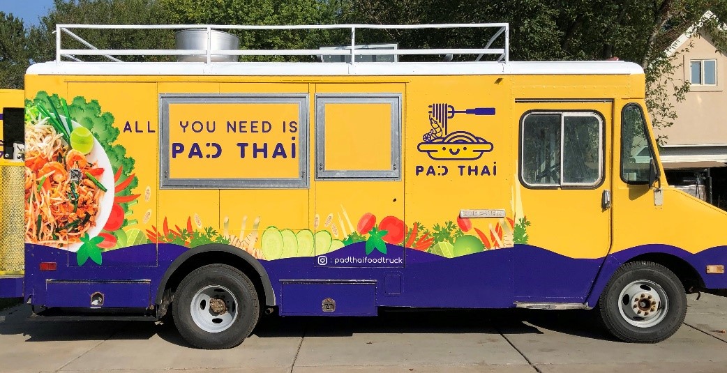 Pad Thai food truck with a noodle bowl and vegetable graphics