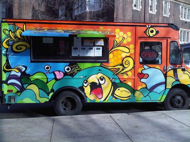 Food truck painted with colorful cartoon bee characters