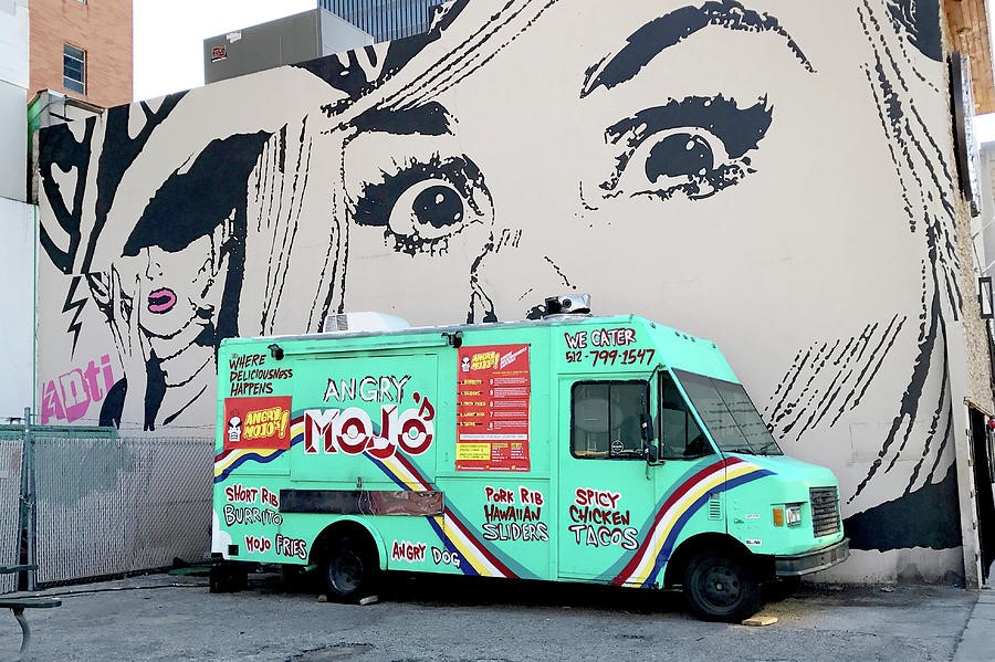 Angry Mojo food truck parked in front of a large wall mural