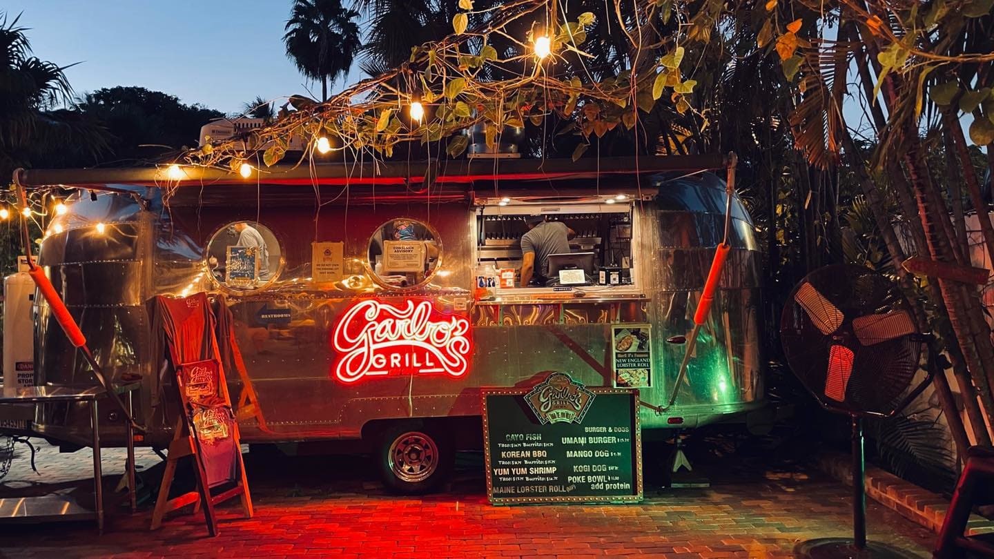 Garbo's Grill food trailer lit with string lights at night