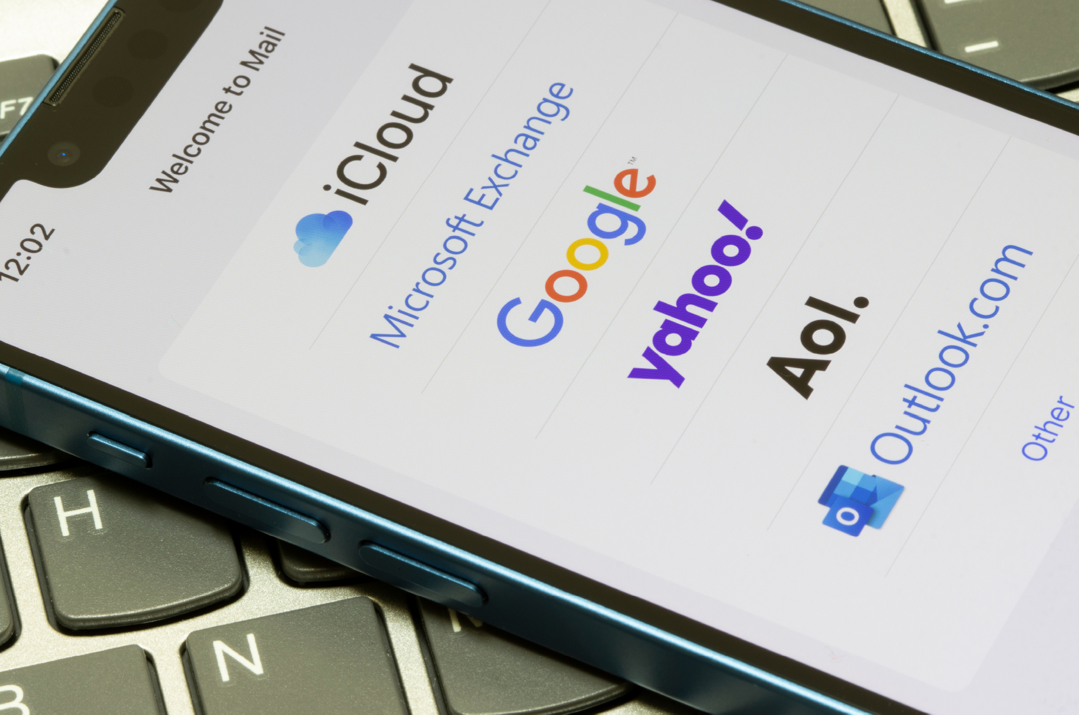 A phone with a list of email providers’ logos