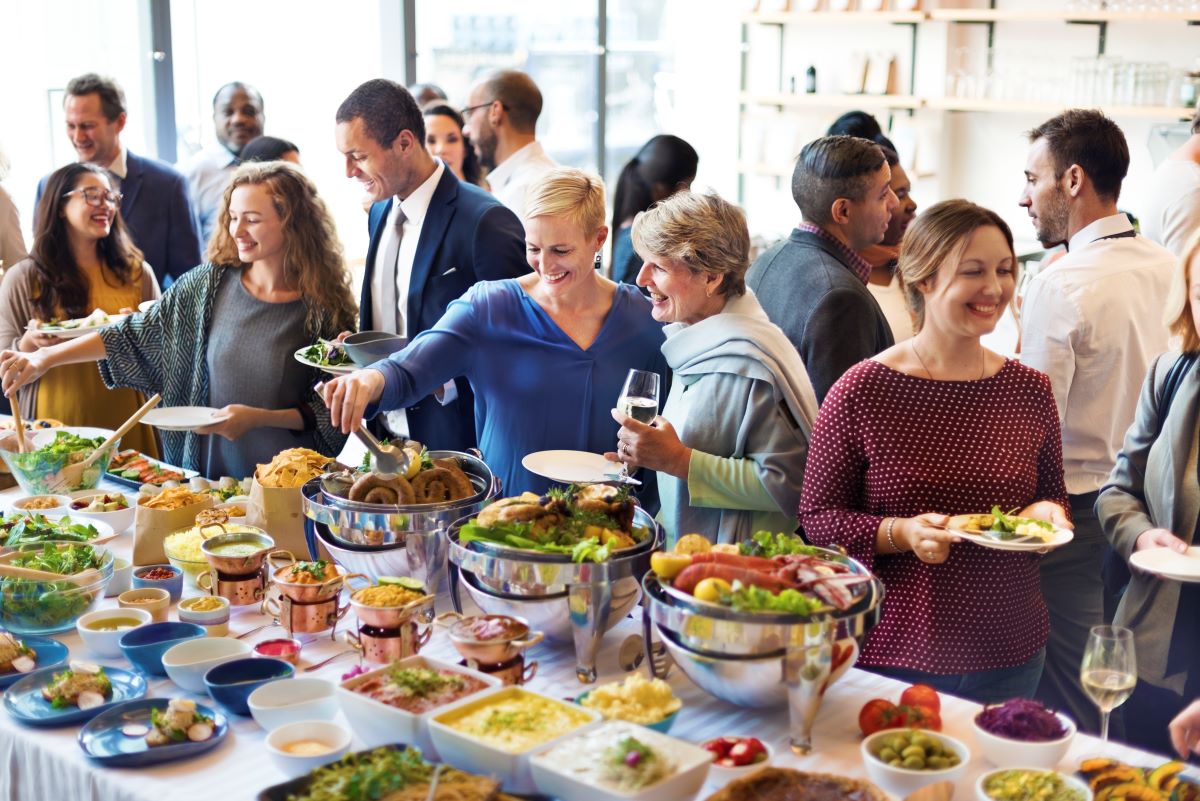 Guests filling their plates at a catered buffet event