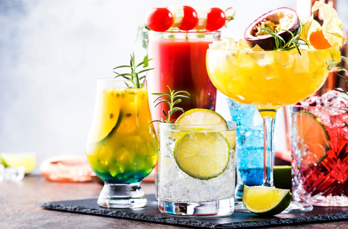 Assortment of colorful mocktails garnished with fruit and herbs