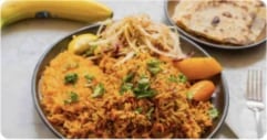 Somali rice dish served with flatbread and a banana