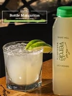 Bottled margarita beside a filled glass
