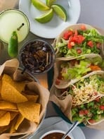 Tacos served with tortilla chips and salsa