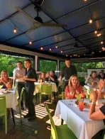 Guests dining on a string-lit patio