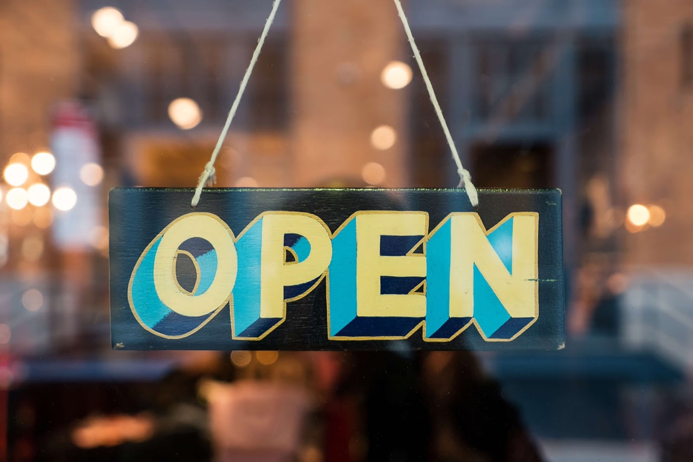 An OPEN sign hanging in a restaurant window