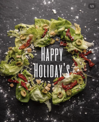 A wreath-shaped salad with "Happy Holiday's" text overlaid