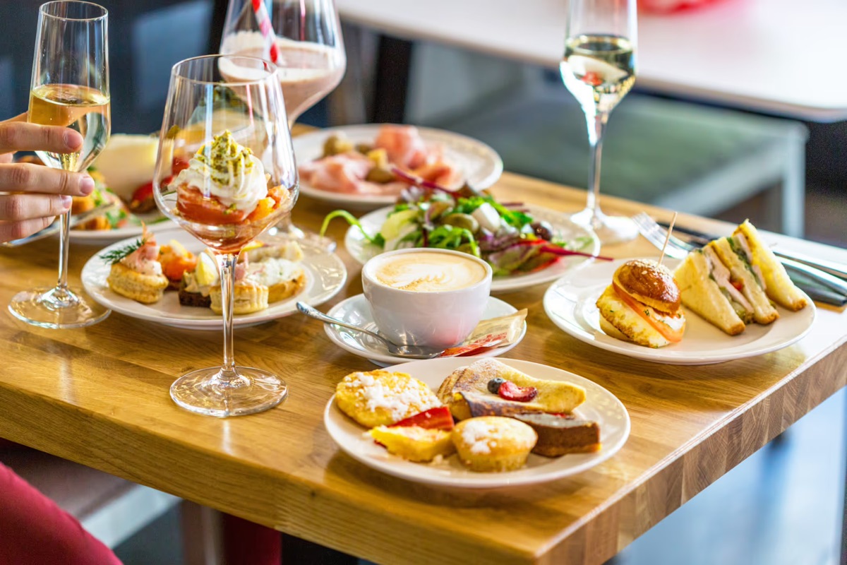 An assortment of restaurant appetizers, coffee, and drinks on a table